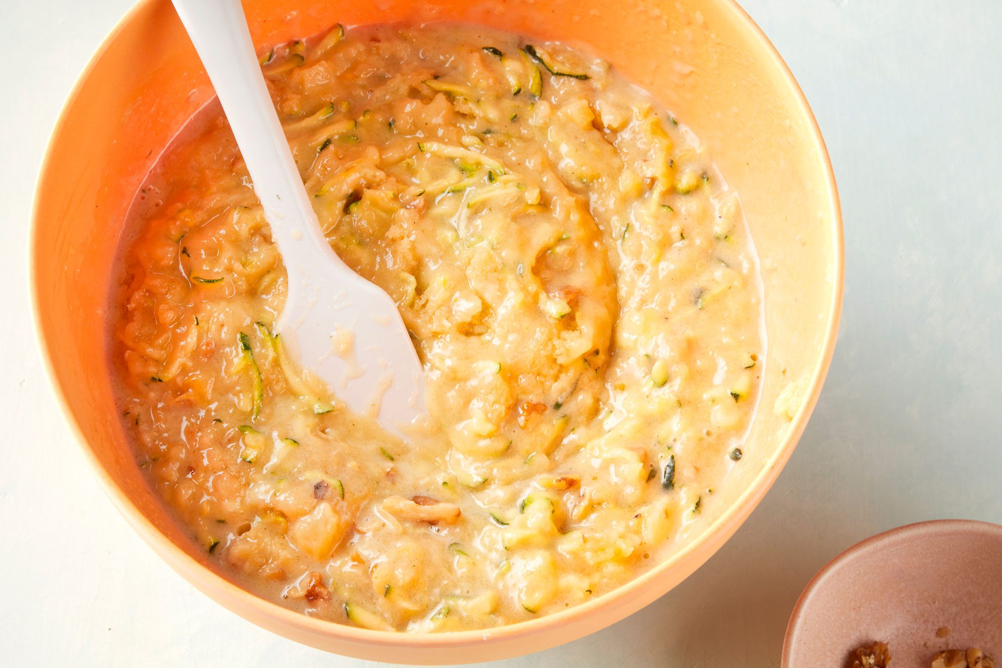 high angle shot of pina colada zucchini bread batter in a large bowl