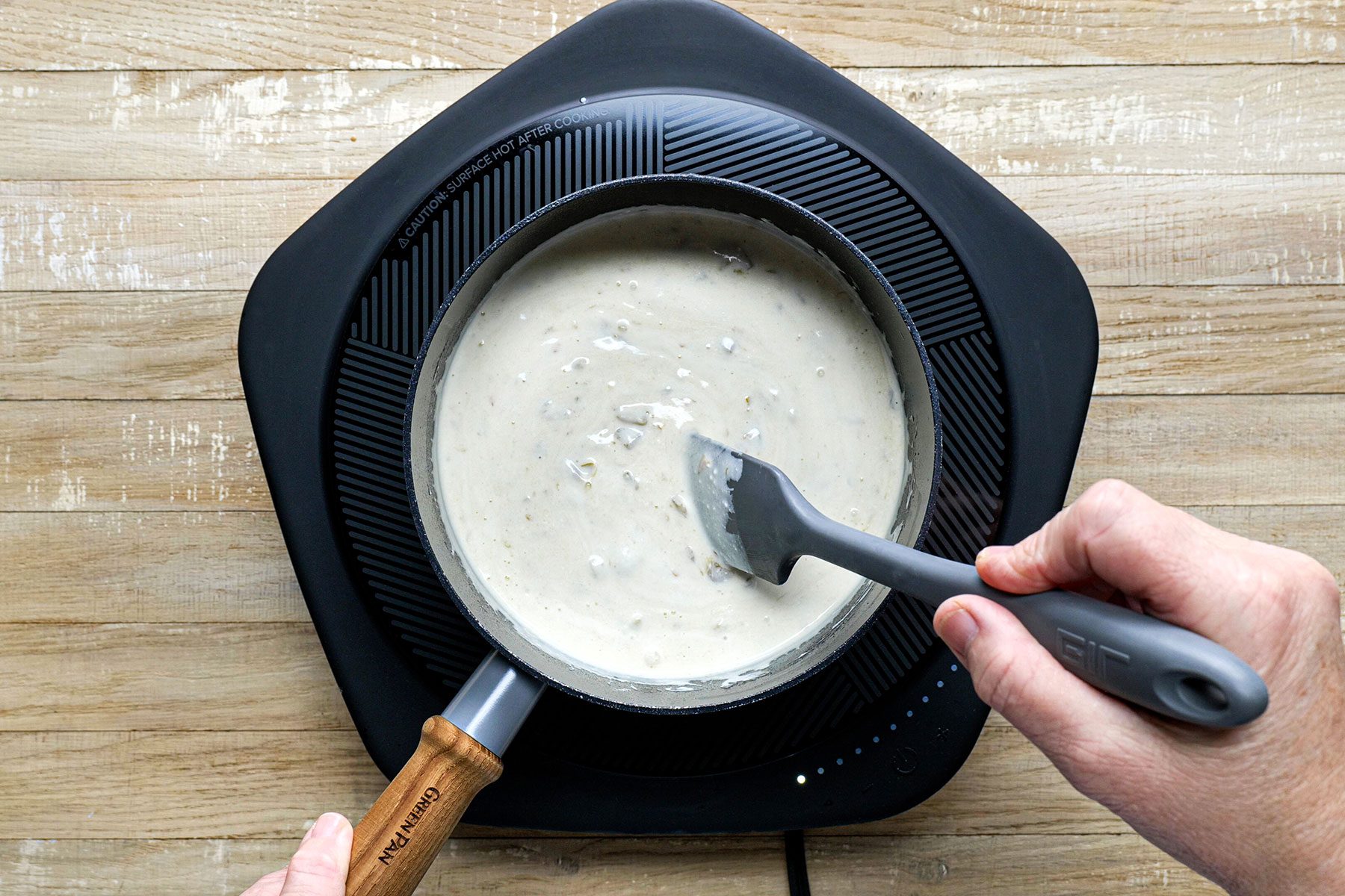 Stirring the dip to make it thick in saucepan