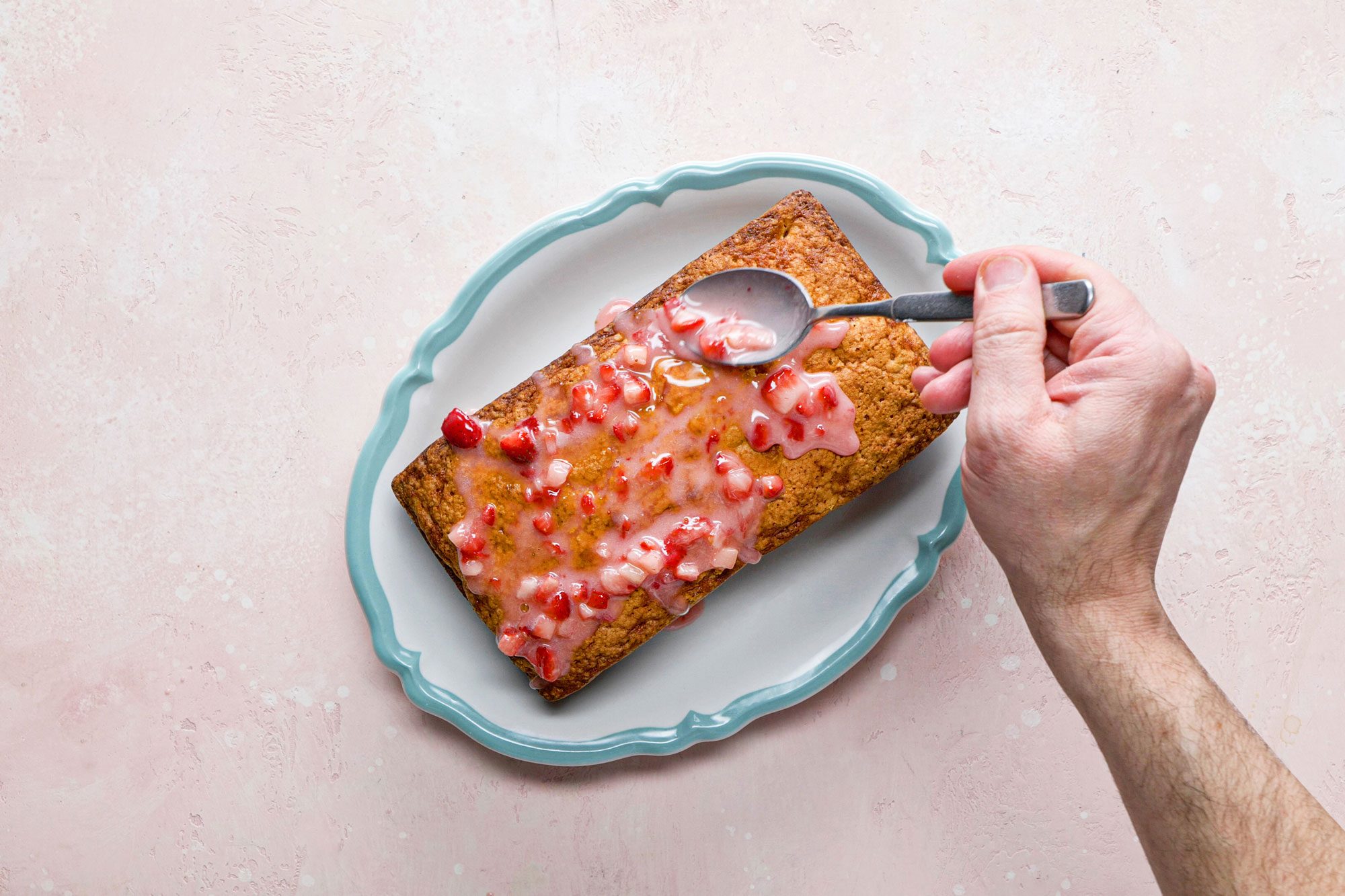 Pour the glaze over the top of the cooled pound cake with the spoon