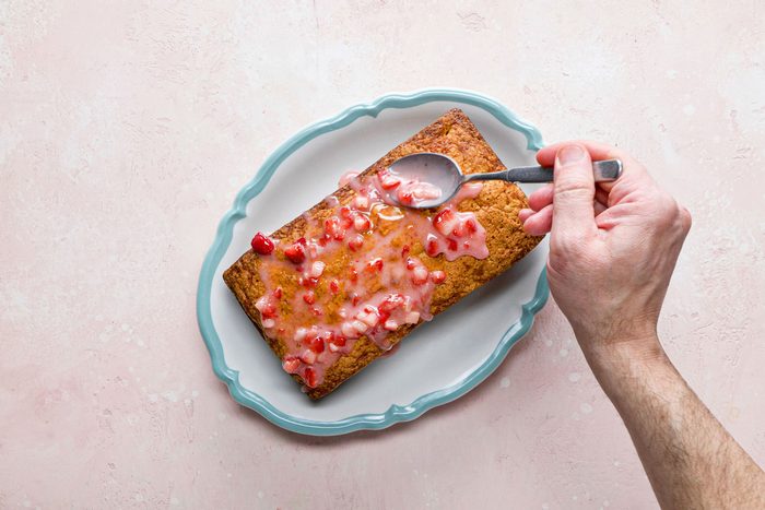 Pour the glaze over the top of the cooled pound cake with the spoon