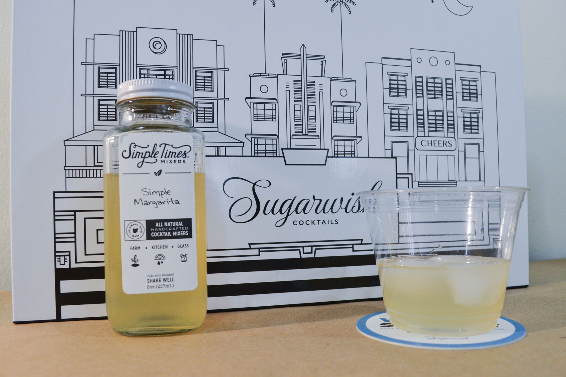 Sugarwish Cocktail Mixer with a glass and a jar on a table