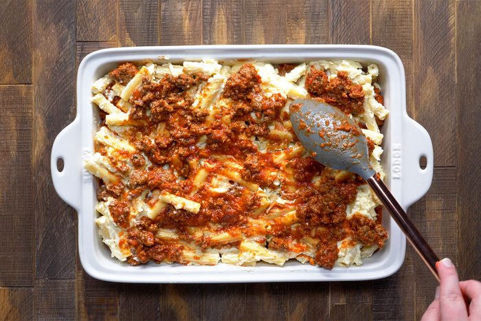 overhead shot of meat sauce spreaded over pasta