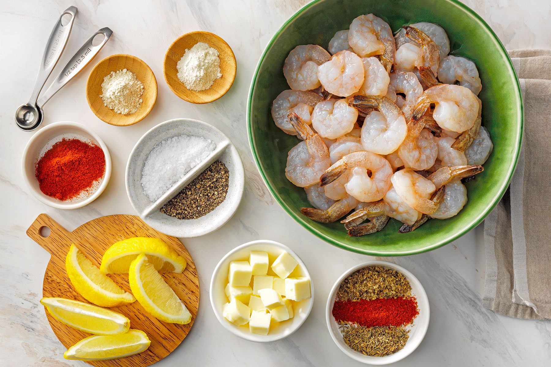 Overhead shot of all ingredients; kitchen towel; white marble background;