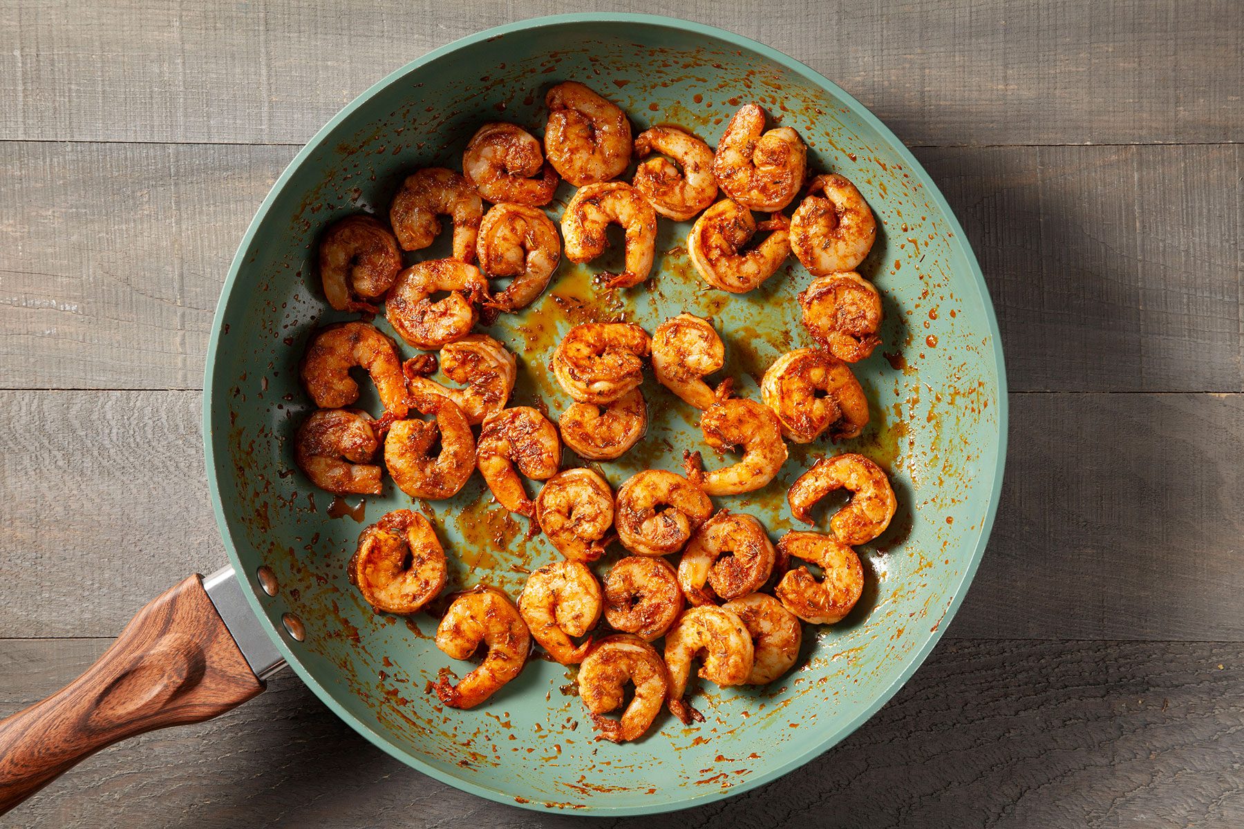 Shrimp mixed with spices in pan