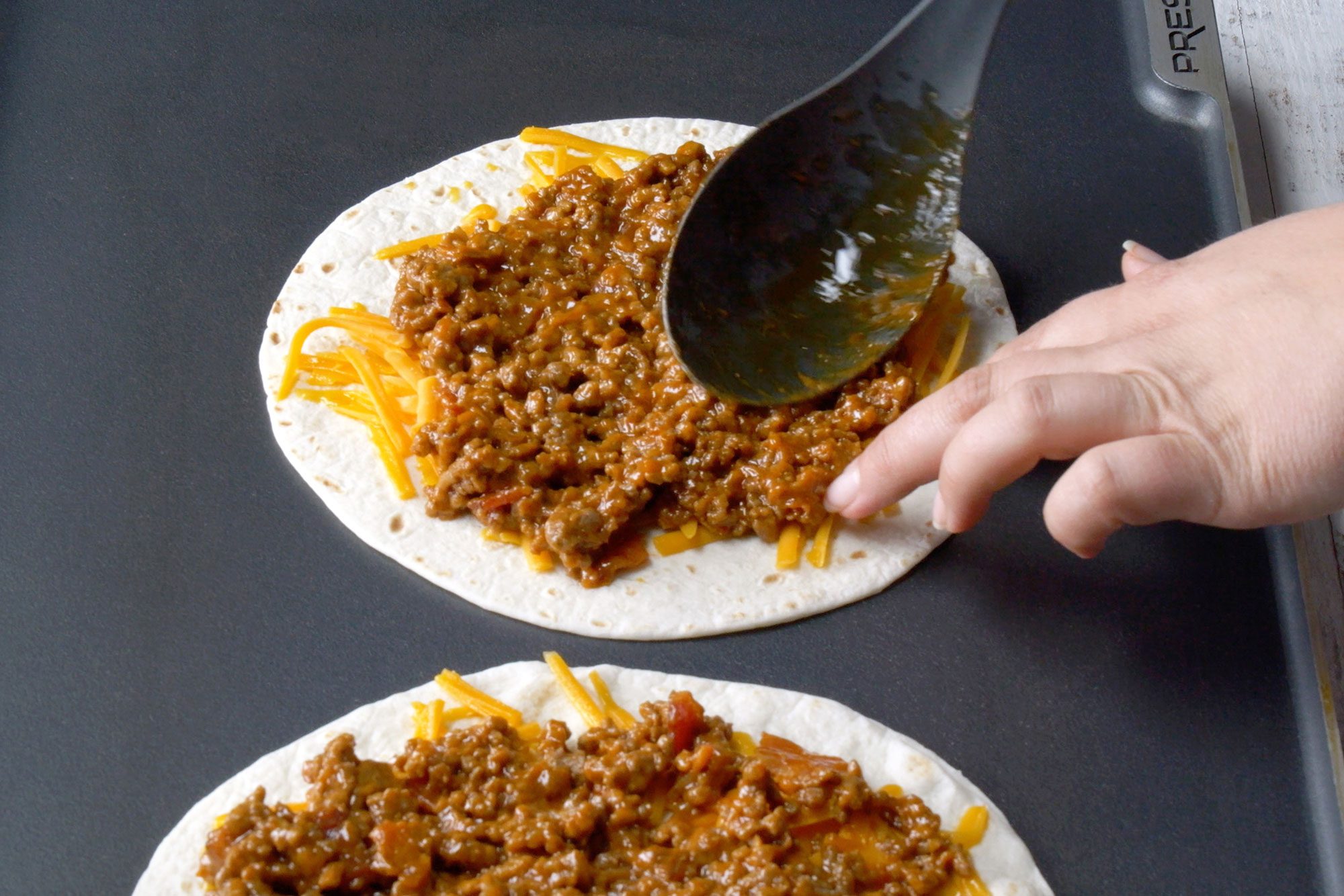 high angle shot of beef mixture spreaded on tortillas