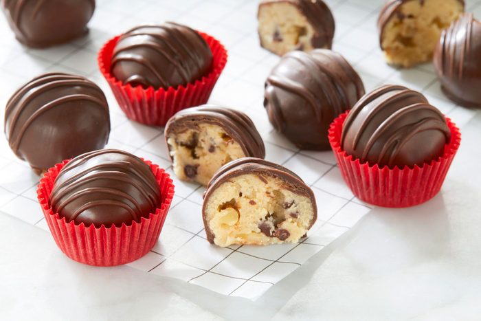 Delicious Cookie Dough Truffles coated in chocolate on a white background