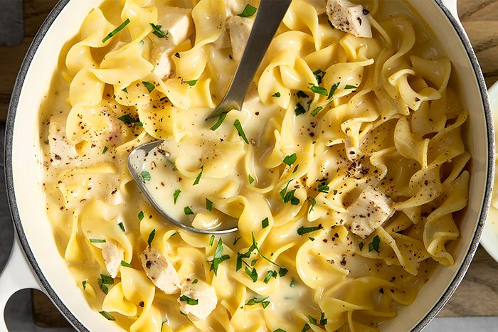 overhead shot of chicken noodle soup in a pan