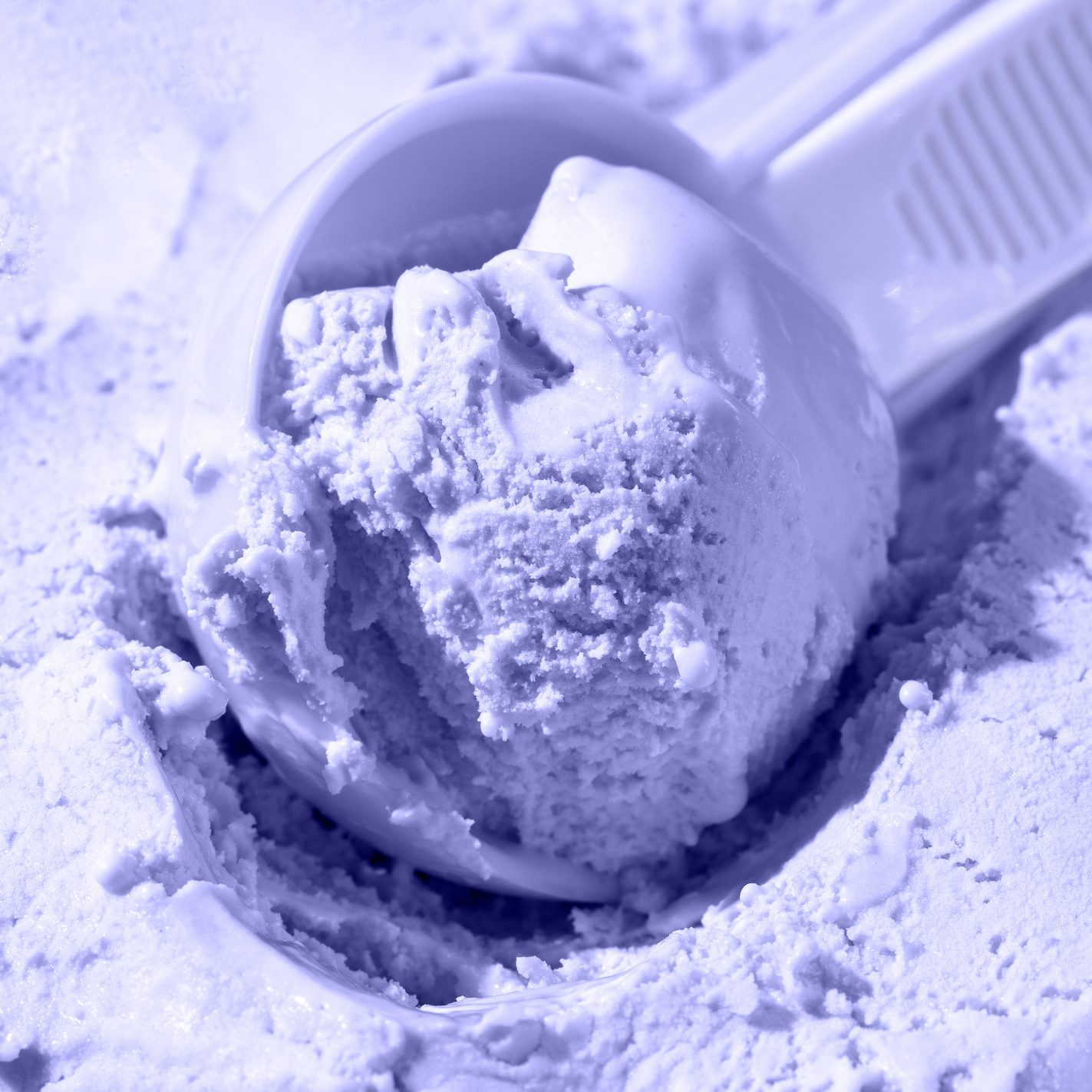 Close up of scoop with ice cream ball. Toning in the color of the year 2022, very peri. Trendy colors concept.