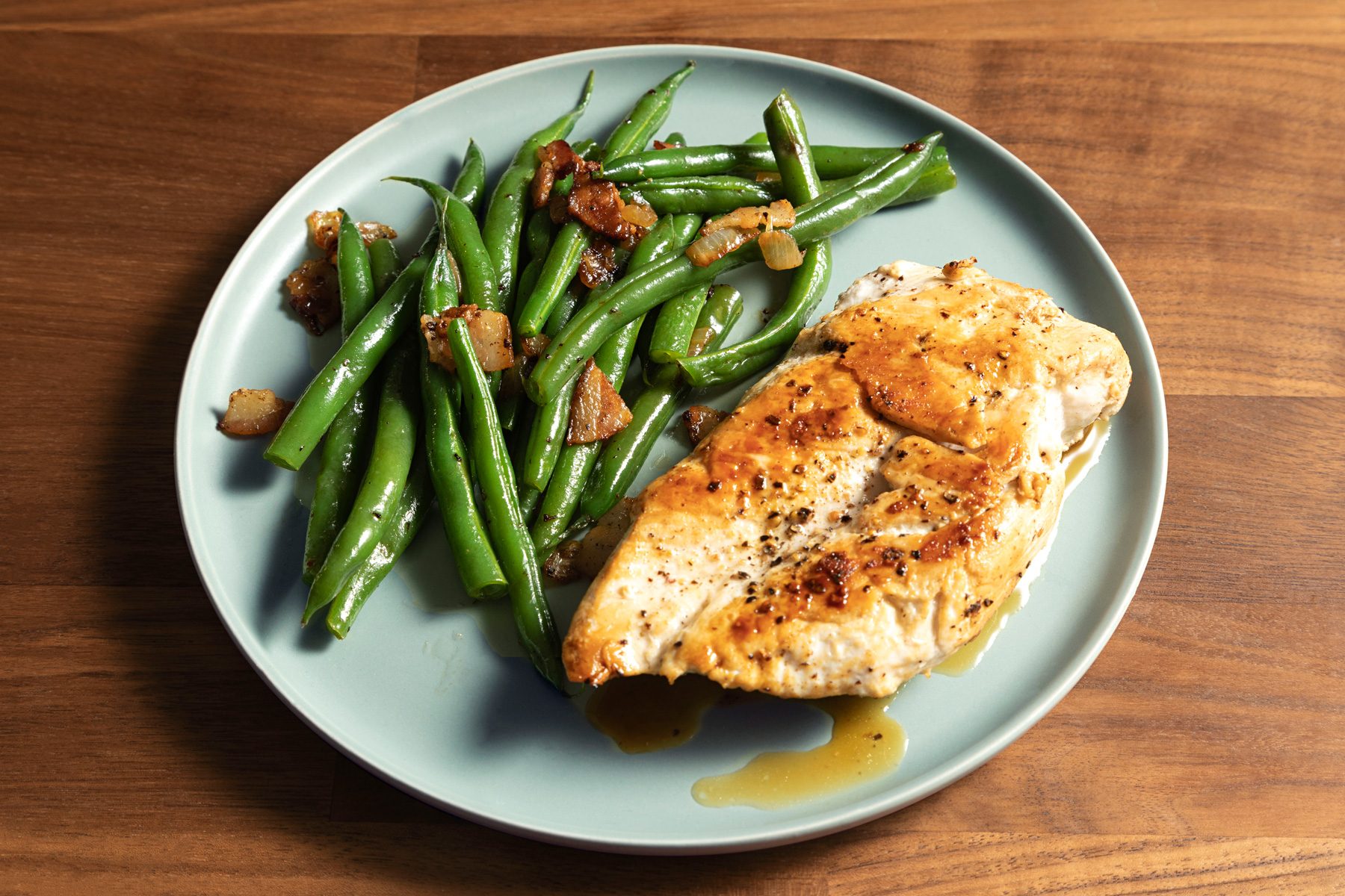 A plate of green beans served with meatloaf