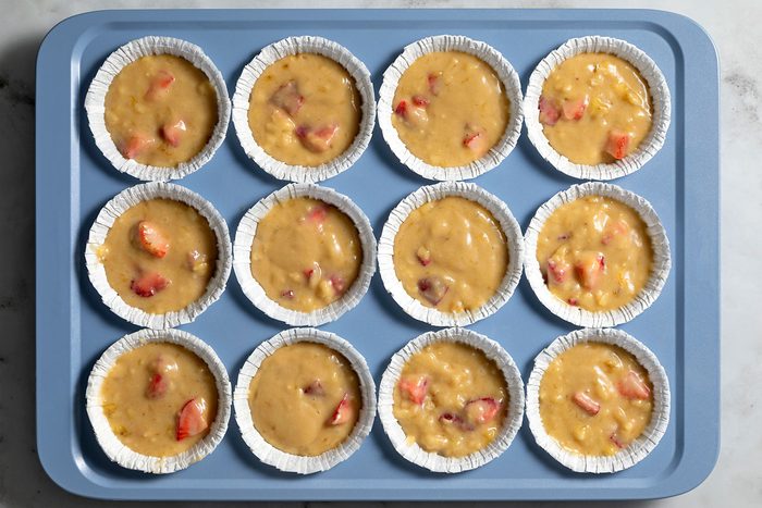 overhead shot of strawbeery banana muffin batter in the cups