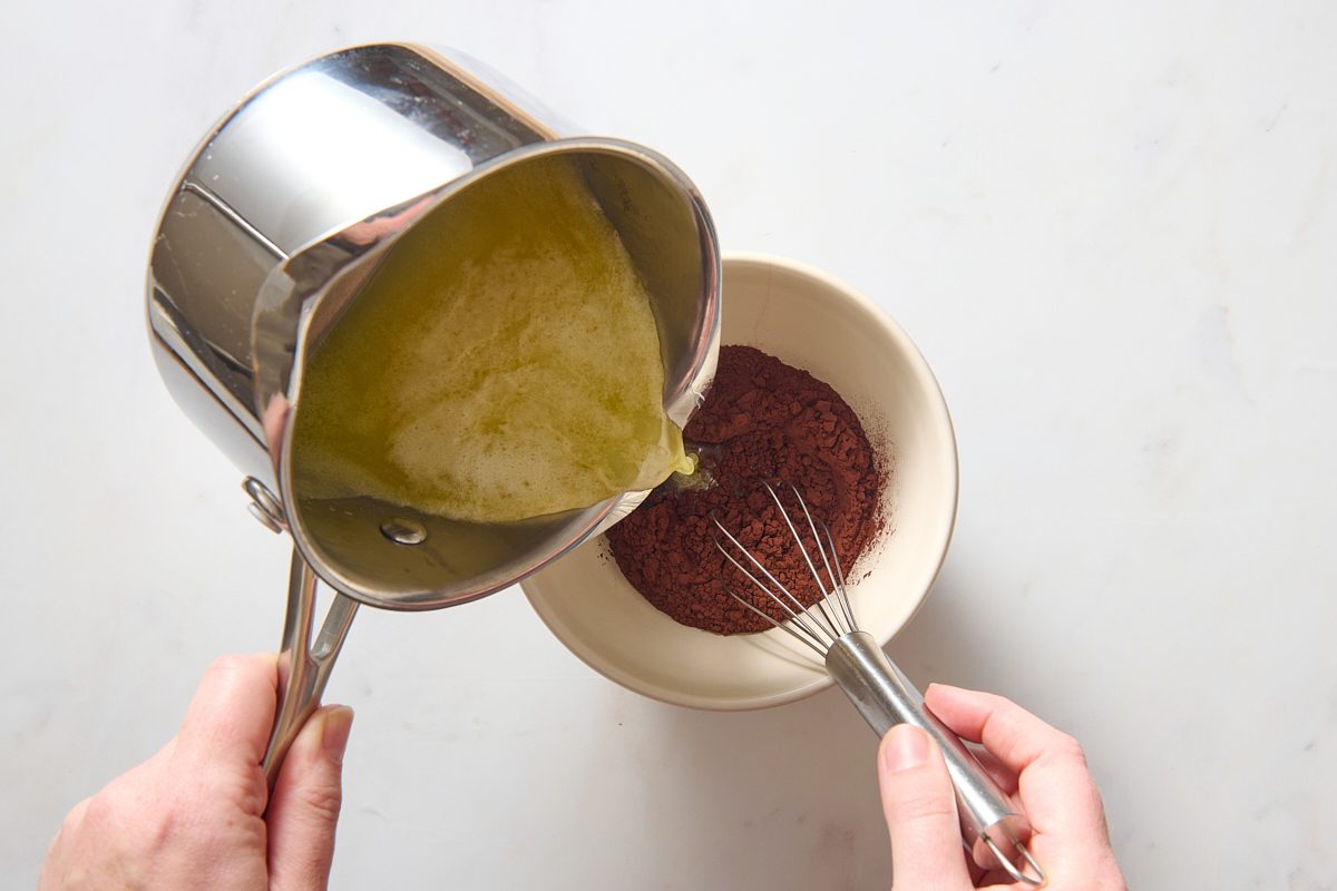 Whisking the hot liquid into the cocoa powder
