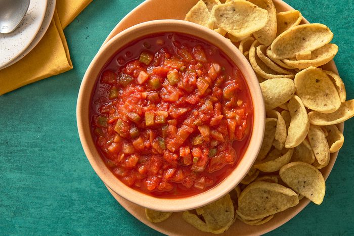 Overhead shot of chunky salsa in a bowl with some chips