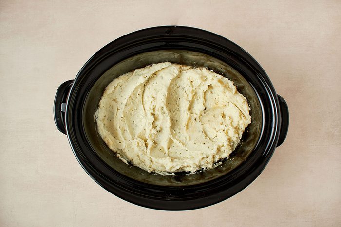 Cook mashed potatoes in crockpot.