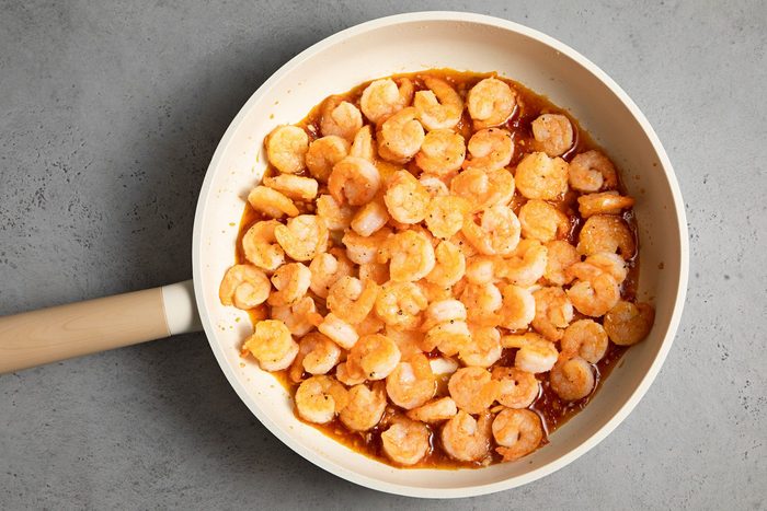 overhead shot of shrimps added in the mixture