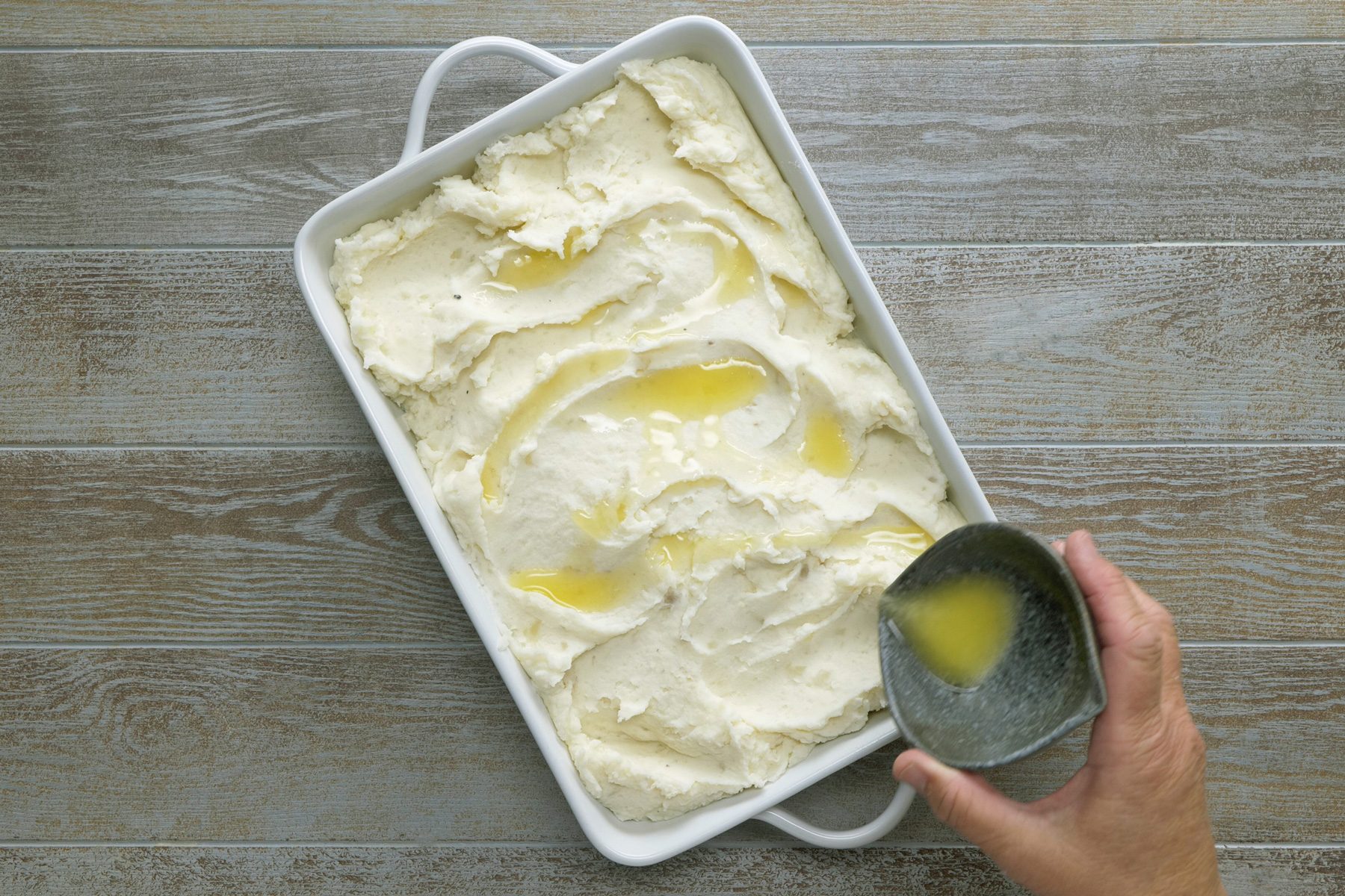 Add melted butter over the mashed potato mix