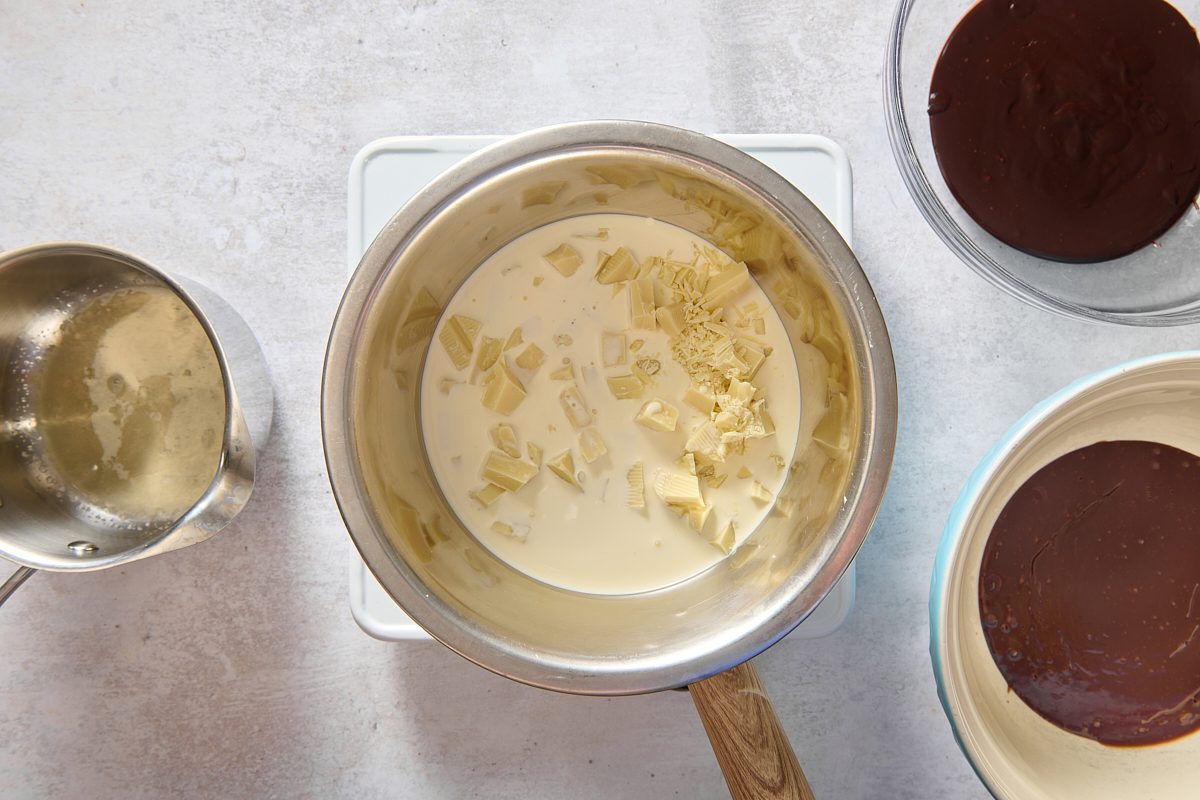 Melting white chocolate and cream over a pan of water