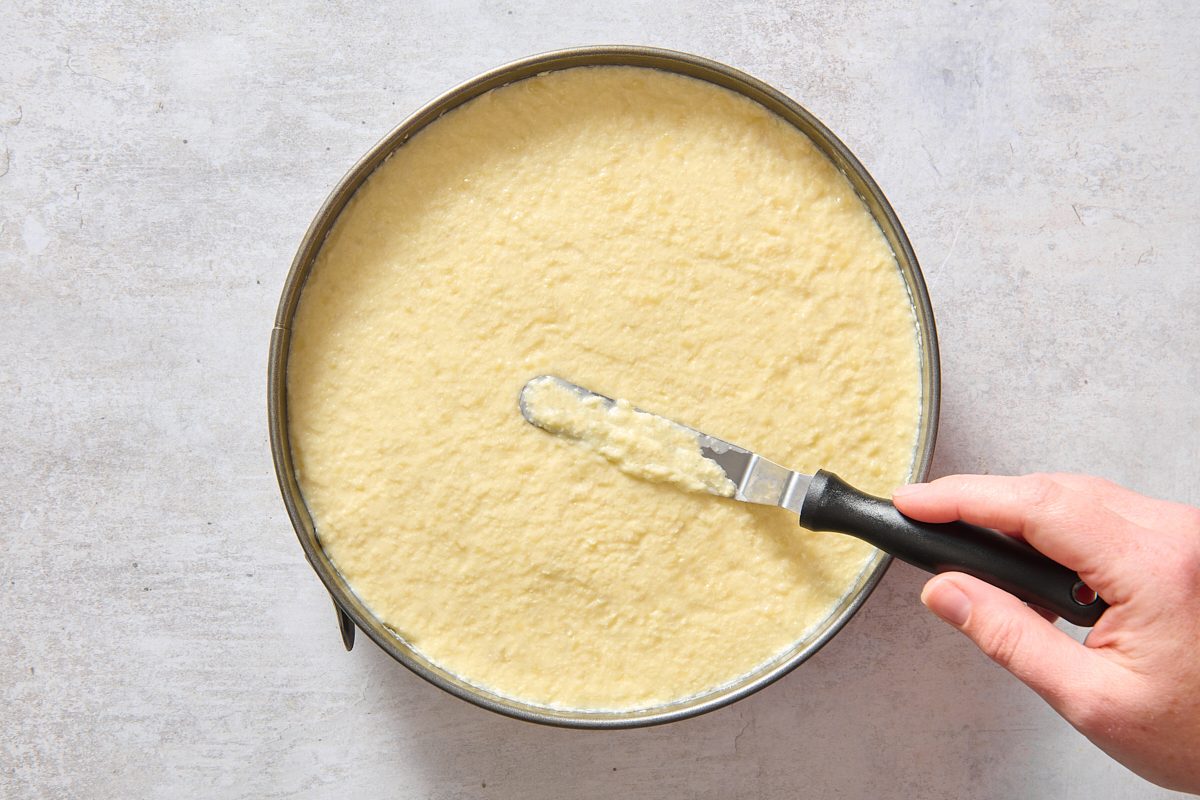 Smoothing the top layer of the cake with a spatula