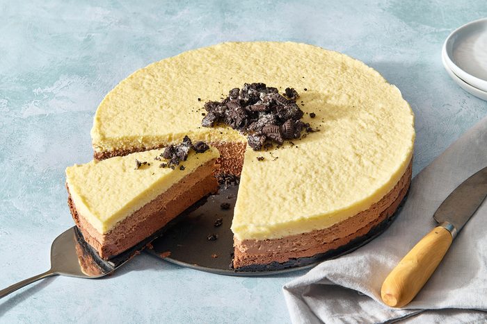 Triple chocolate mousse cake with a slice being removed