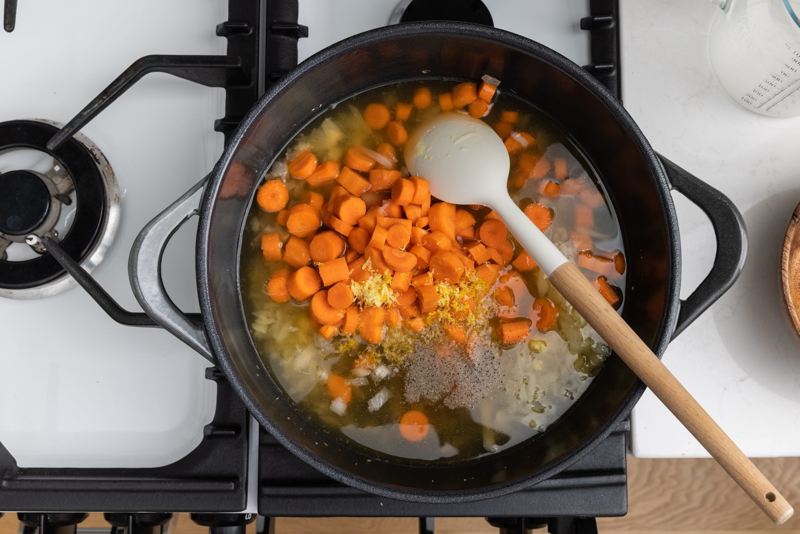 Veggies being cooked in dutch oven on stove top.