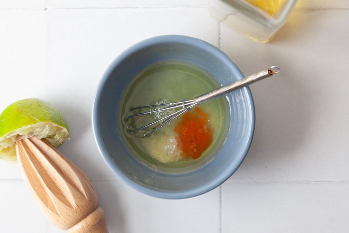 Step 1 of Taste of Home Summer Corn Salad is to make the dressing by combining olive oil, lime juice hot pepper sauce and salt