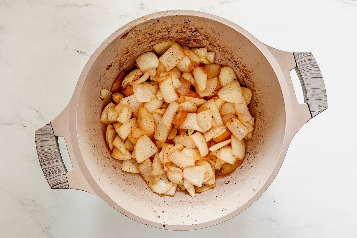 Browned onions in a Dutch oven for Taste of Home venison stew