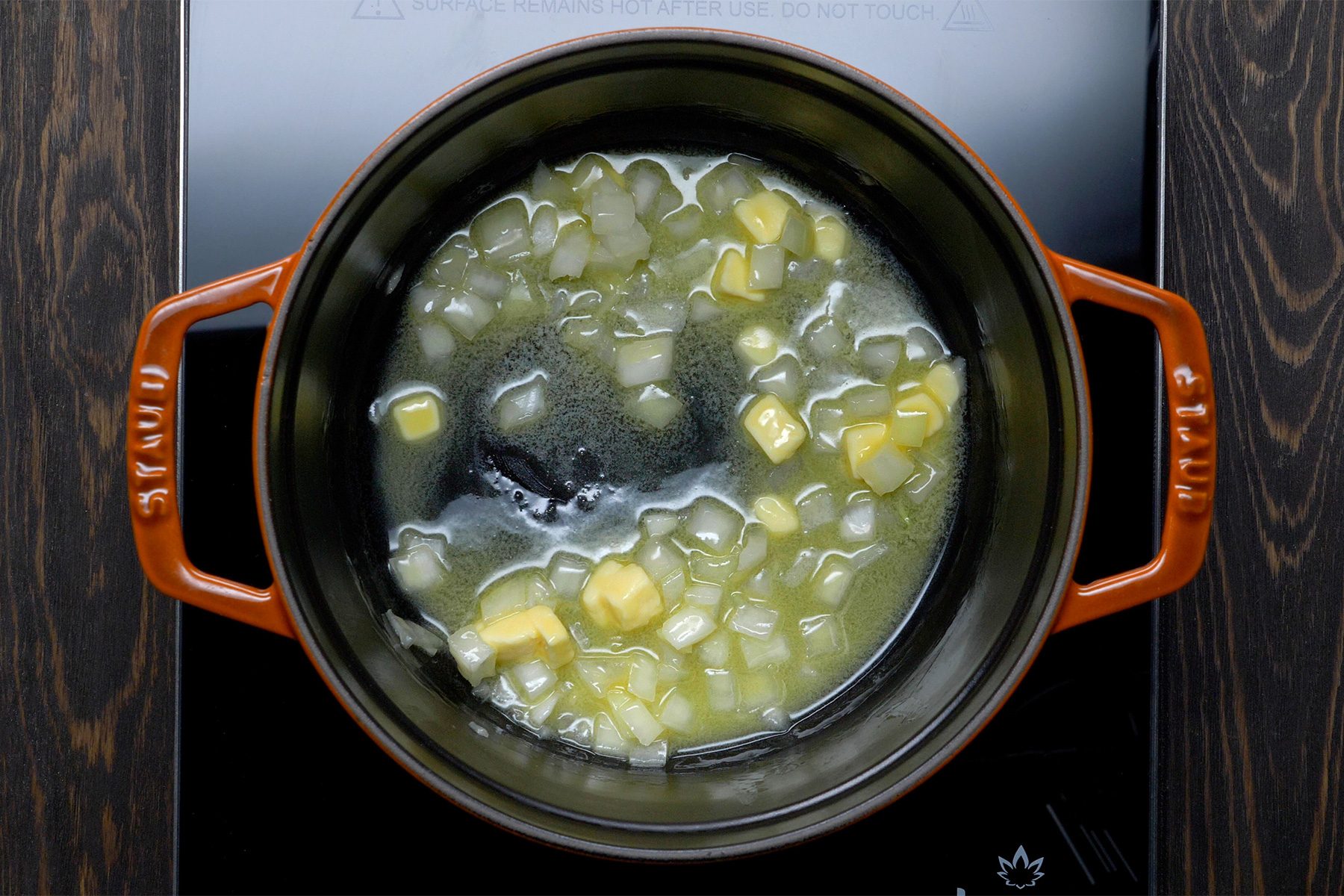 overhead shot; wooden background; In a small saucepan, saute onion in butter until tender;