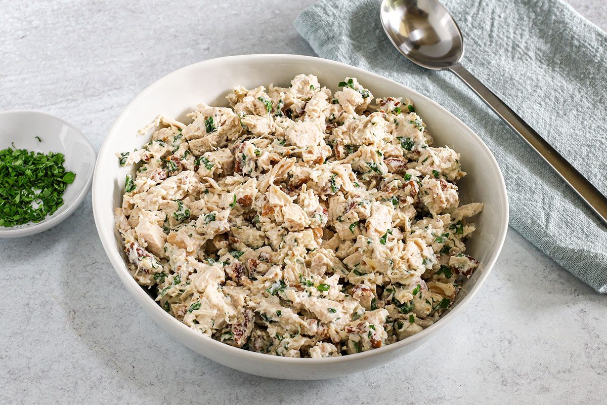 A Serving Bowl With Chicken Salad With Greek Yogurt For Taste Of Home.