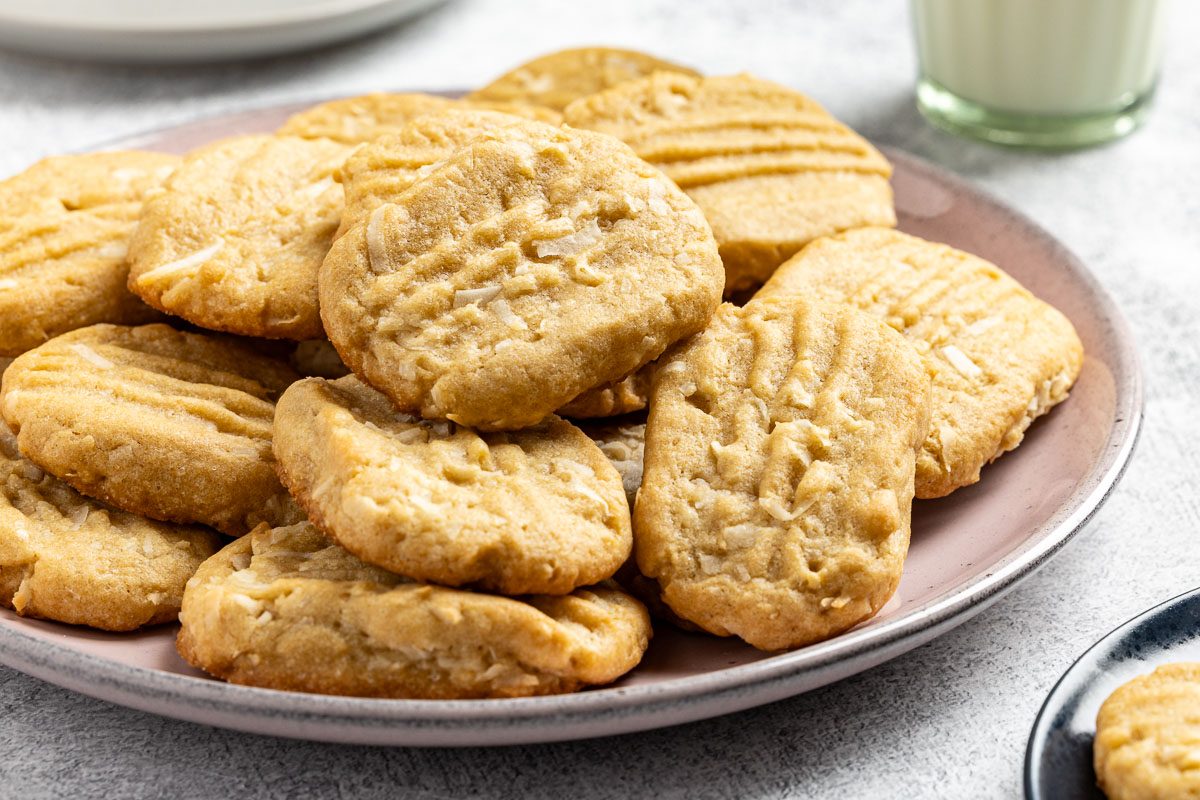 Taste of Home Coconut Cookies recipe photo of the finished recipe on a serving platter and plates.
