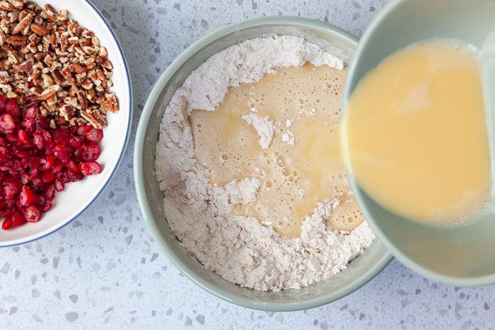 Step 3 of Taste of Home Cranberry Muffins is to combine the orange juice, lightly beaten eggs and vanilla extract. Whisk until well blended. Gradually pour the wet ingredients in to the dry ingredients, then stir until the mixture is just moistened.