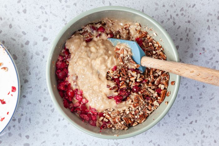 Step 4 of Taste of Home Cranberry Muffins is to mix in the cranberries and pecans