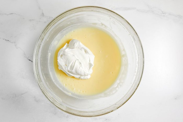 Filling ingredients for Taste of Home Easy Tiramisu in a glass bowl on a marble surface