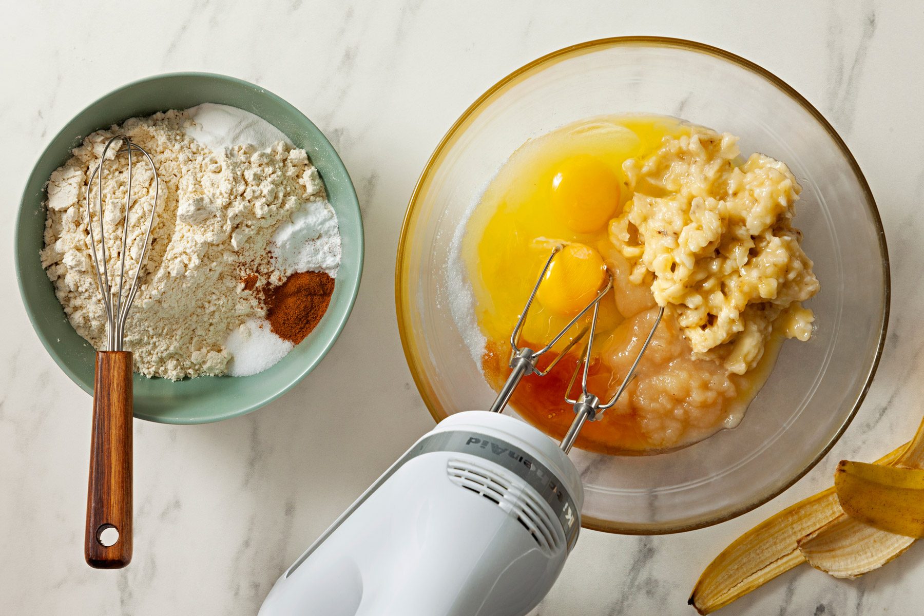 Bananas, sugar, eggs, applesauce, canola oil, orange juice and vanilla are blended in a large bowl.