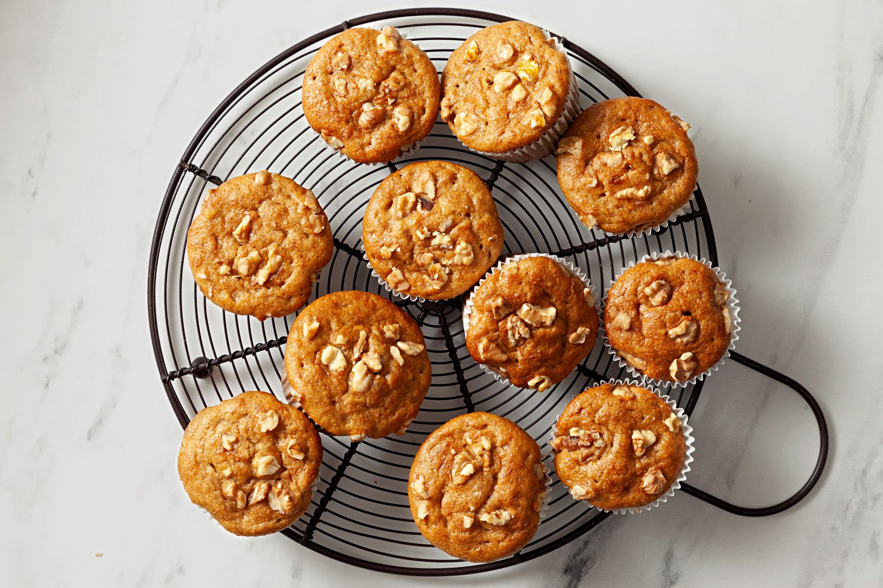 Baked muffins cooling on a wire rack.