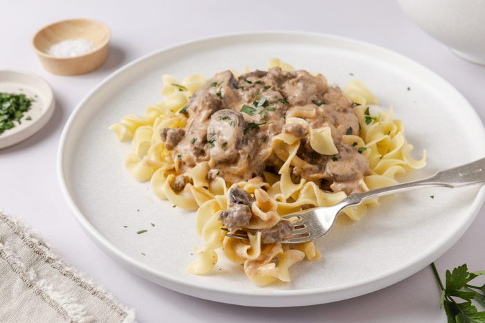 Stroganoff served on plates garnished with fresh parsley.