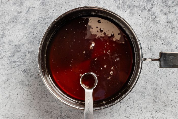 Taste of Home Homemade Pancake Syrup recipe photo of adding the maple flavoring to the saucepan.