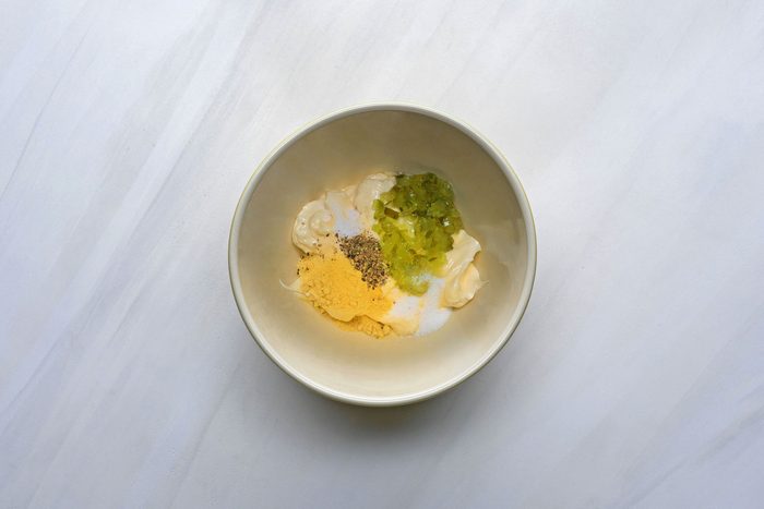 In a small bowl combine mayonnaise, pickle relish, sugar, mustard, salt and pepper