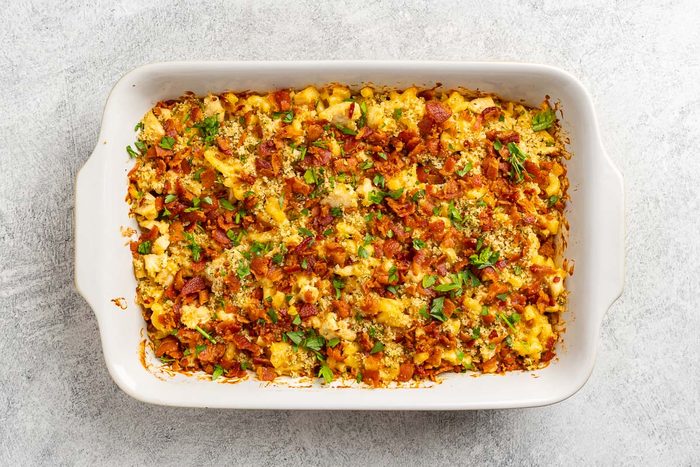 Taste of Home Macaroni and Cheese with Chicken recipe photo of the cooked mac and cheese topped with bacon and parsely.