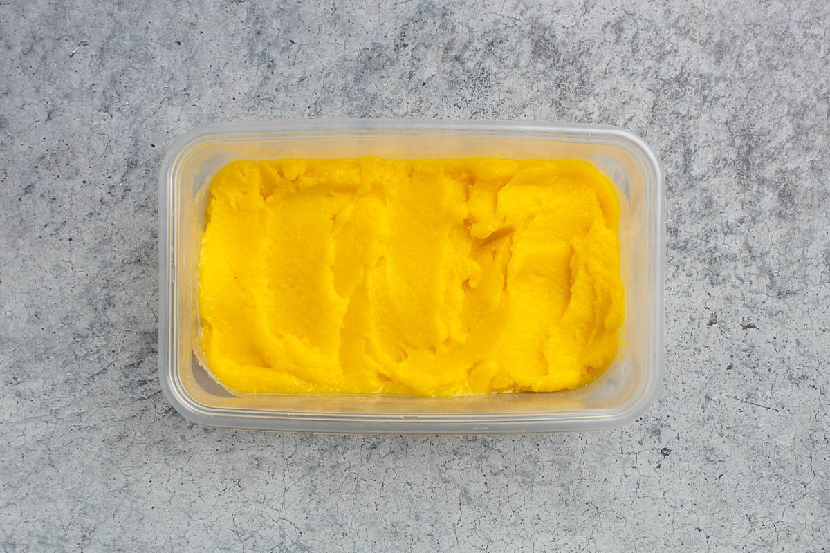 Taste of Home mango sorbet recipe photo of ingredients in a freezer safe container.