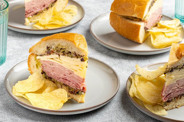 Taste of Home Muffuletta Recipe photo of the finished recipe cut into slices and served on plates.