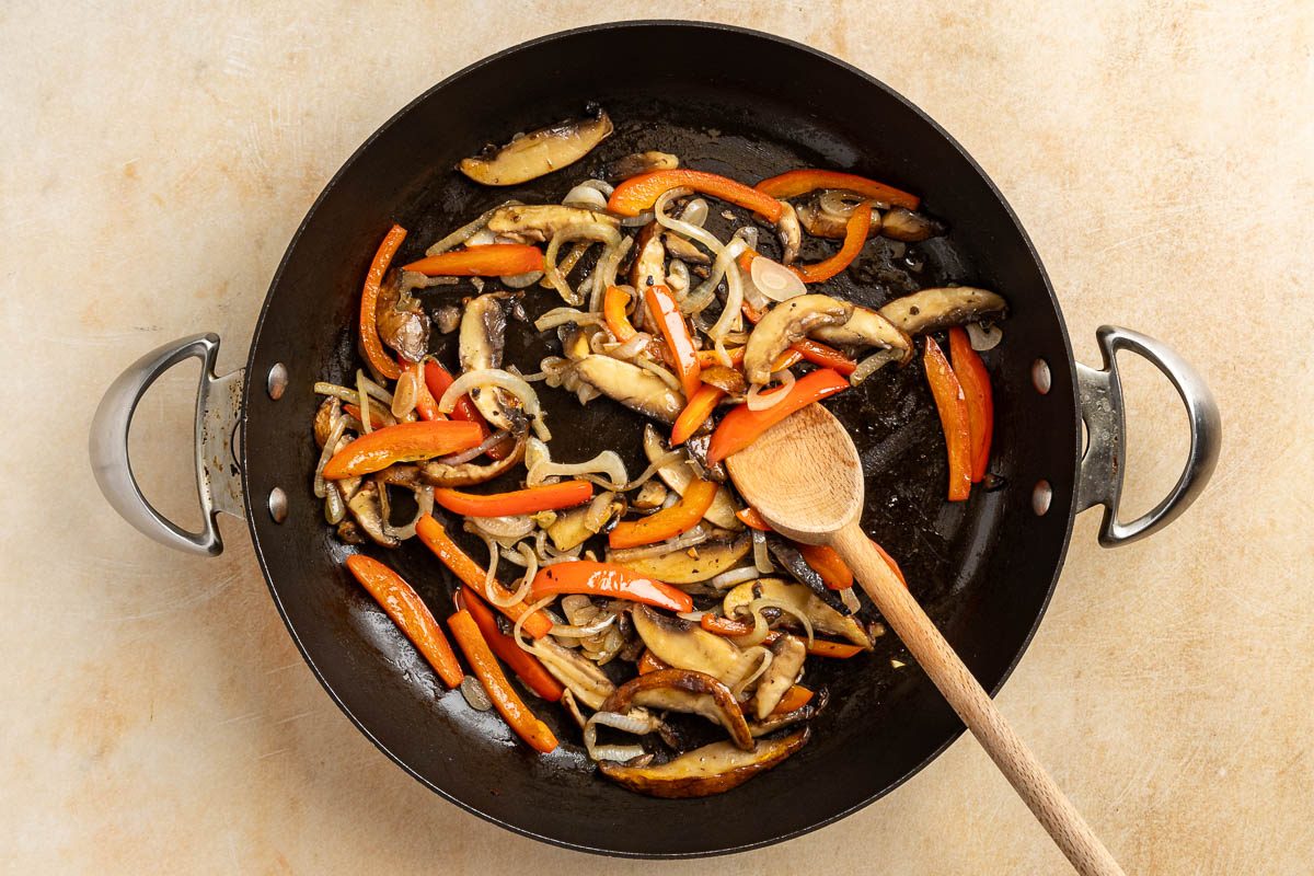 Taste of Home Mushroom Tacos recipe photo of the mushrooms, red pepper, and onion sauteed in a skillet.