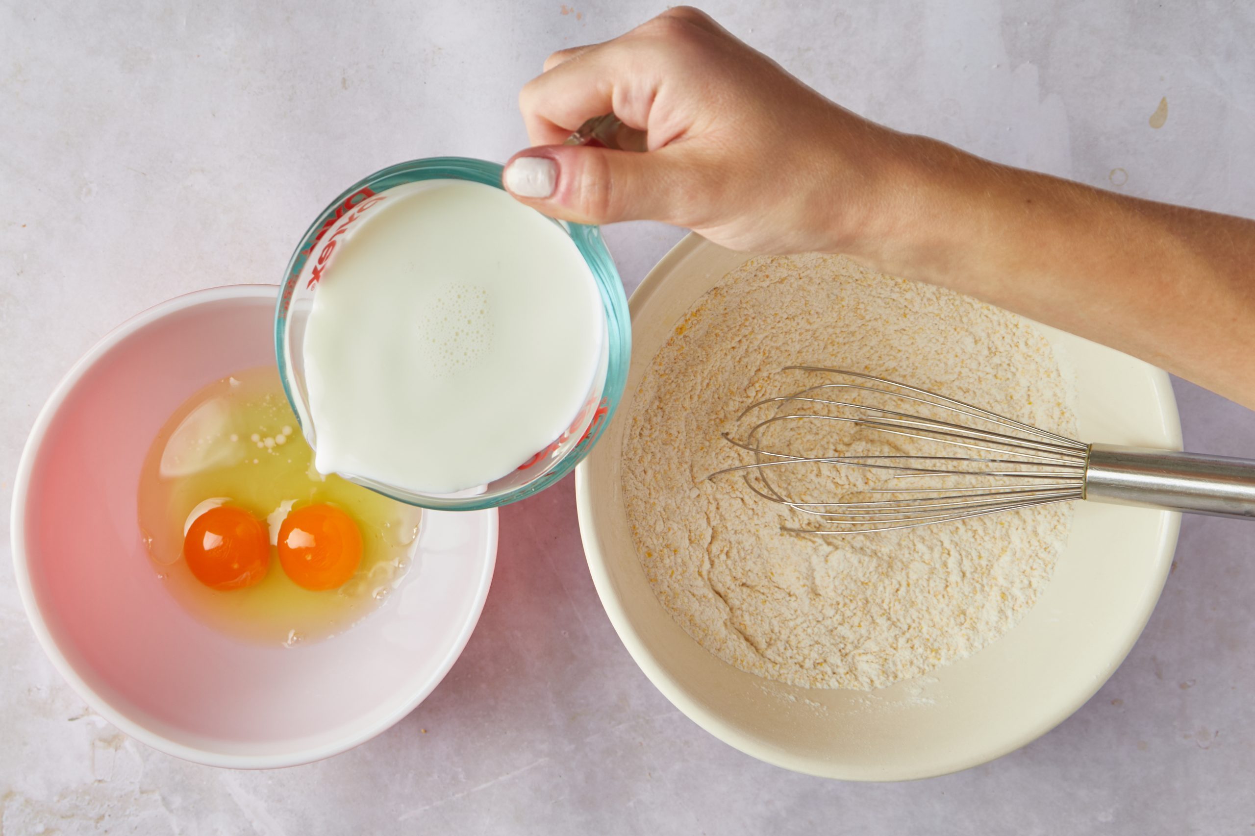 Mix the wet ingredients for cornbread pancakes.