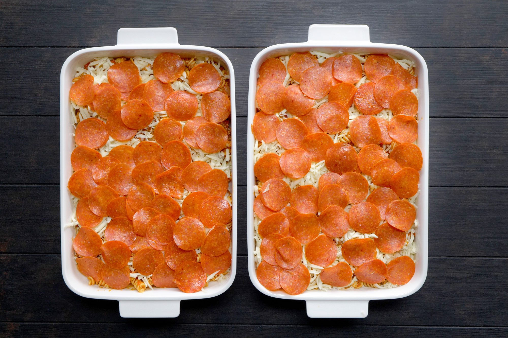 Arranged pepperoni over the top of the pasta in baking dish