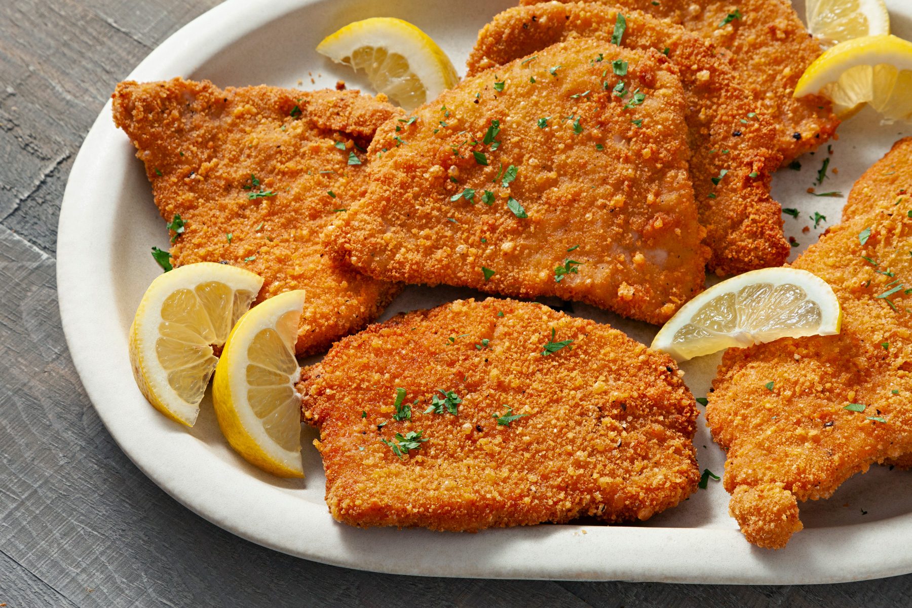Pork Milanese served with Lemon on a plate