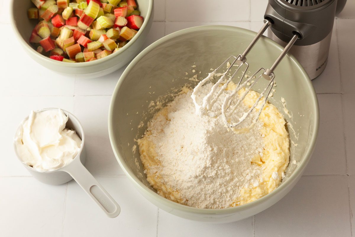 Step 2 of Taste of Home Rhubarb Coffee Cake is to combine the flour, baking powder, baking soda and salt. Add this dry mixture to the creamed mixture, alternating with the sour cream. Fold in the rhubarb. Spread the batter into a well-greased 13x9-inch baking dish.