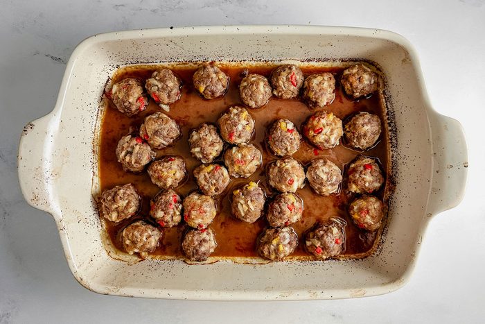 Taste of Home teriyaki meatballs in a white ceramic dish on a marble surface