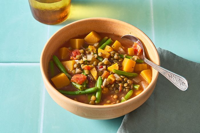 Vegetable Lentil Soup in a bowl with a spoon
