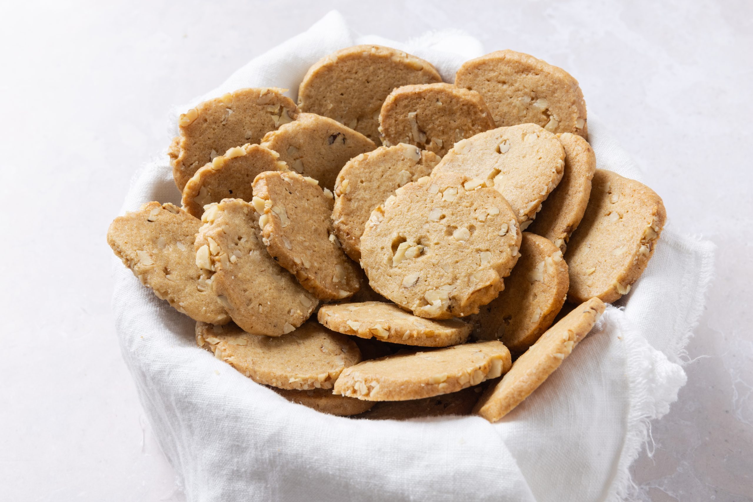 Walnut cookies in bowl.