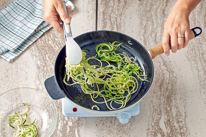 Zucchini Noodles being cooked in a pan