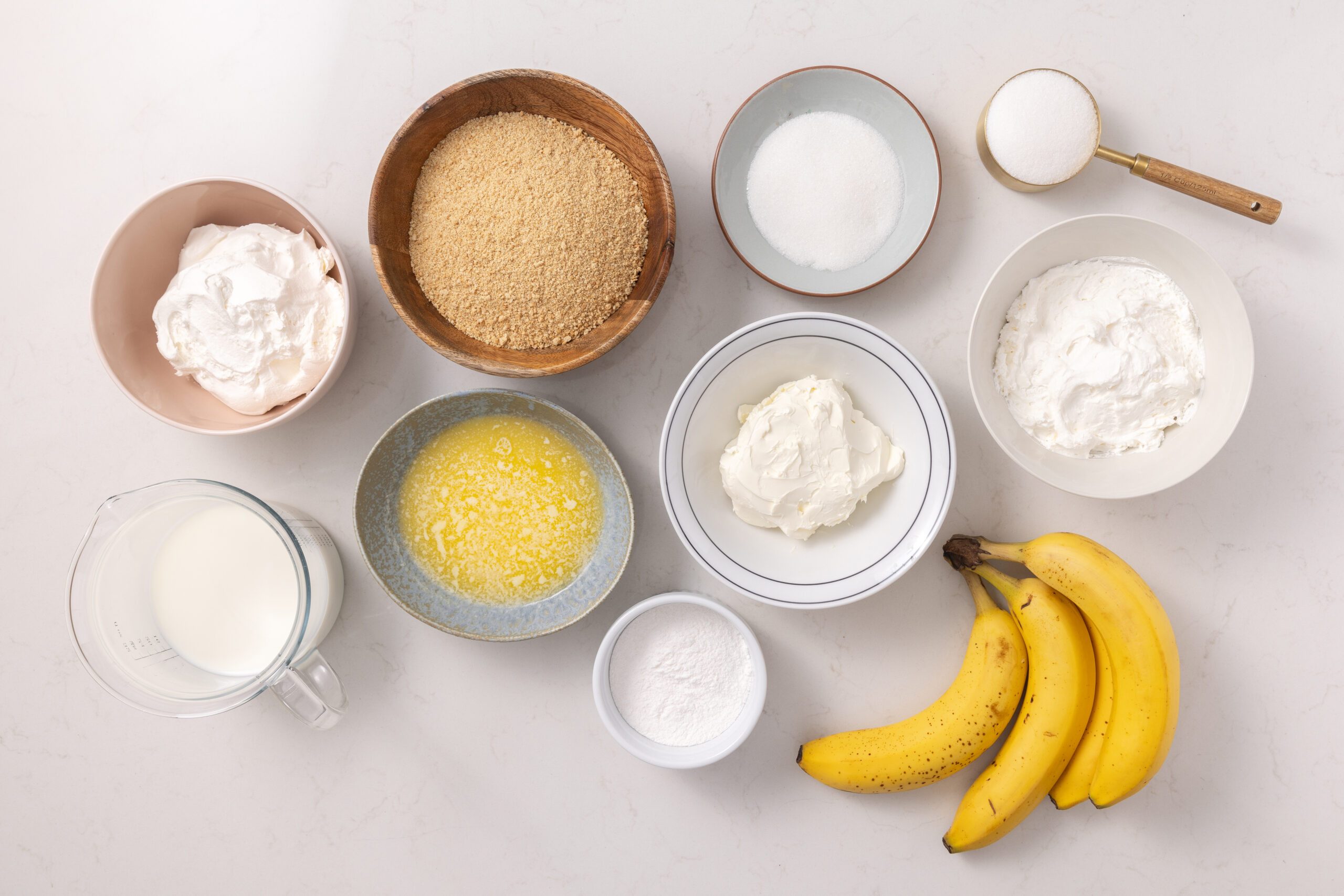 Ingredients for banana cream cheesecake on kitchen counter.