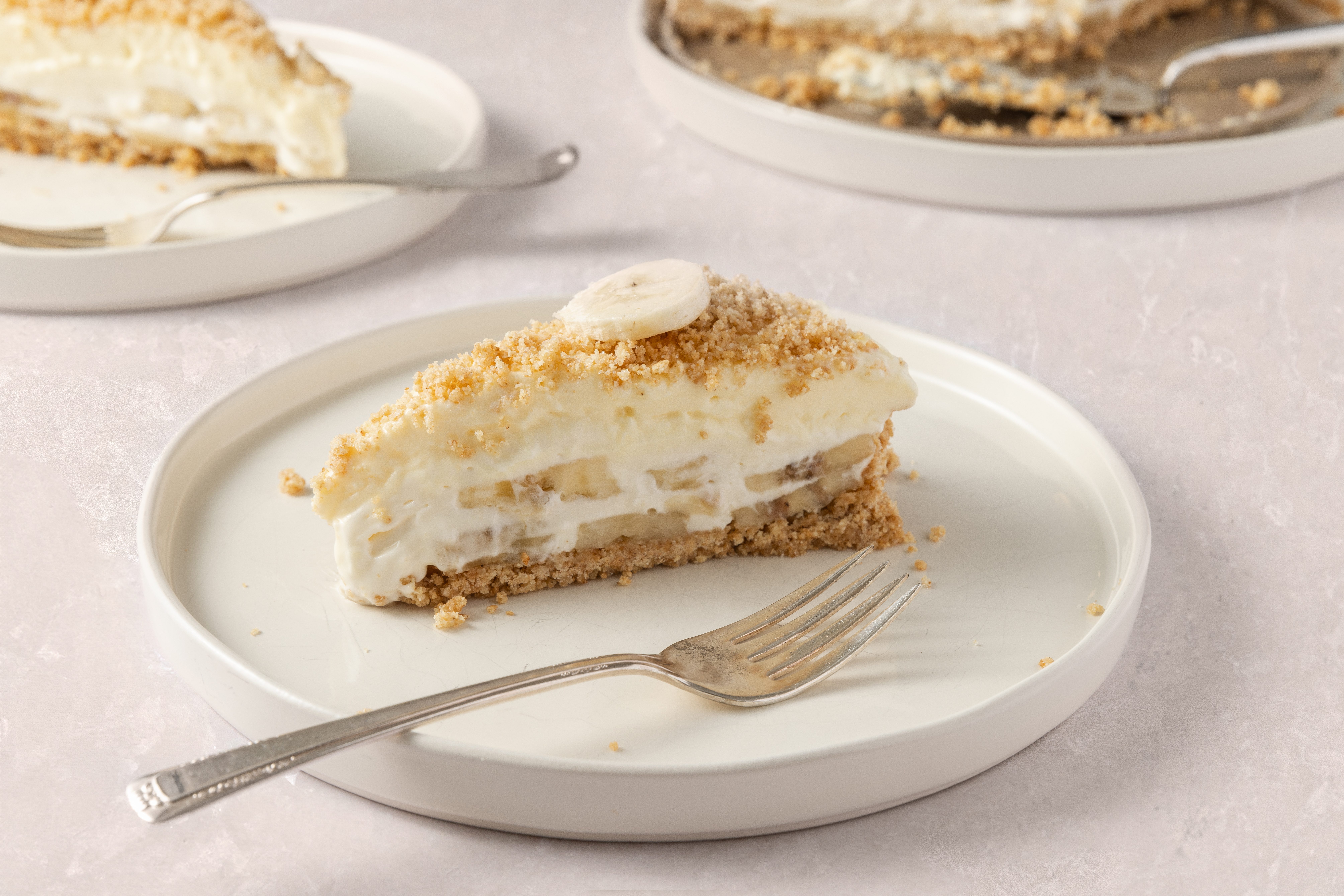 Banana cream cheesecake slices served on plates.